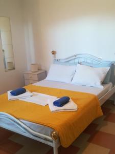 a hospital bed with towels on top of it at Serifos Palace in Livadakia