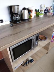 a kitchen counter with a wooden counter top with a tv at Vila Bachkovo in Bachkovo