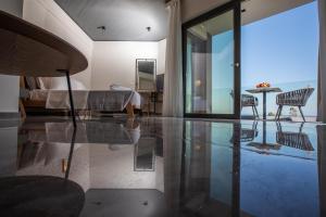 a bedroom with a bed and a table and chairs at Tramonto Suites in Xi