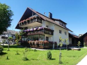 a large house with flowers on the balconies at Ferienwohnung Diepold in Wasserburg