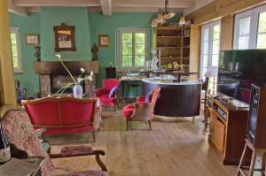a living room filled with furniture and a fireplace at Les Fous de Bassans in Poullan-sur-Mer