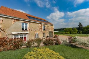 an old house with a garden in front of it at Gîte La Fontagrille in Épineuil-le-Fleuriel