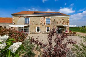 an old house with a garden in front of it at Gîte La Fontagrille in Épineuil-le-Fleuriel