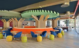 a restaurant with colorful chairs and tables in a cafeteria at Sol Katmandu Park & Resort in Magaluf