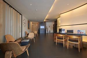 a waiting room with chairs and a counter in a building at The Leverage Business Hotel - Bandar Baru Mergong in Alor Setar