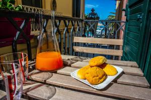 a table with a plate of biscuits and a bottle of orange juice at Terra Del Sole in Trani
