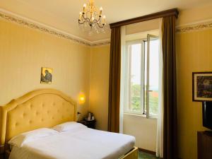 Postel nebo postele na pokoji v ubytování Grand Hotel Excelsior