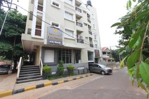 a building with a car parked in front of it at Livi Suites - Premium 1 BHK Serviced Apartments in Bangalore