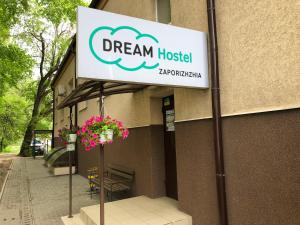 a sign on a pole in front of a building at Dream Hostel Zaporizhia in Zaporozhye