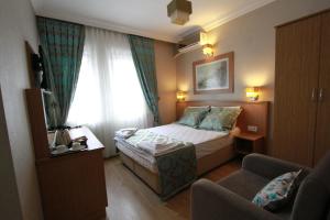 A bed or beds in a room at Agora Boutique Hotel & Bistro