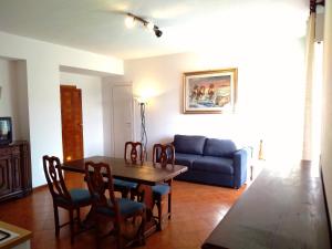 a living room with a table and a couch at ROMANTICA TOSCANA in Scarlino