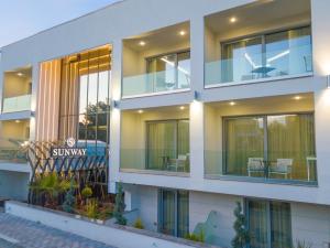 a facade of a building with glass windows at Sunway Hotel in Kallithea Halkidikis