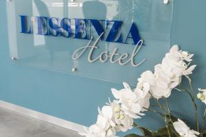 a sign for a hotel with white flowers at L'Essenza Hotel in Olbia