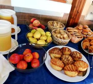 un tavolo blu coperto con ciotole di frutta e dolci di AlmaRé a Palinuro Altre 19 foto