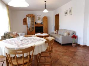 a living room with a table and a couch at Gästehaus Martin in Gamburg