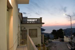 a balcony of a building with a view of the ocean at Peschici HOME FILOCCO stanza e bagno privato in Peschici