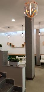 a lobby with a pillar and a light fixture at Hotel Mida in Obzor