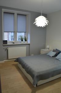 Posteľ alebo postele v izbe v ubytovaní Apartament SZTOKHOLM