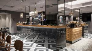 a bar in a restaurant with tables and chairs at Solo Sokos Hotel Turun Seurahuone in Turku +51 photos