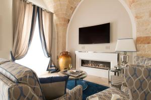 a living room with a couch and a fireplace at Hotel Don Ferrante in Monopoli