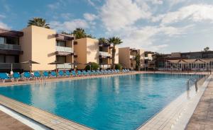 a large swimming pool in front of a hotel at Hotel Palia Don Pedro in Costa Del Silencio