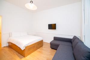 a living room with a couch and a bed at Knightsbridge Apartments in London