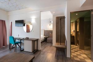 a room with a desk and a room with a bedroom at Metropolitan in Thessaloniki