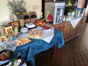 a blue table with plates of food on it at B&B Sobe Lušina in Sečovlje