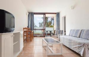 a living room with a couch and a tv at Hotel Palia Don Pedro in Costa Del Silencio