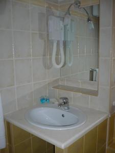 a bathroom with a white sink and a mirror at Hotel Ristorante Antica Marina in Nicotera Marina