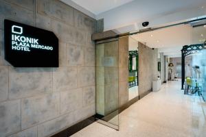 a lobby of a hotel with a sign on the wall at Ikonik Plaza Mercado in Salamanca