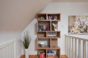 a staircase with wooden book shelves in a room at Luxury Apartment, bed and breakfast in Galway