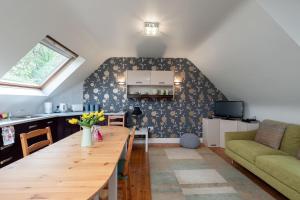 a kitchen and living room with a wooden table at Luxury Apartment, bed and breakfast in Galway
