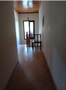 a hallway with a table and a chair in a room at Snowland Hotel in Murree +8 photos
