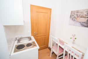 a small kitchen with a sink and a wooden door at NADA in Karlovac