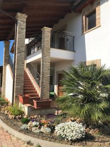 a house with stairs and flowers in front of it at Il Podere del Carlone in Vasto