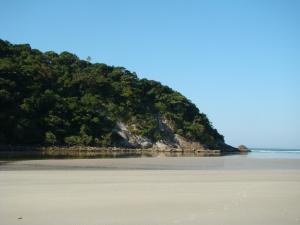 an island in the ocean with a sandy beach at Pousada Y-Goá in Bertioga