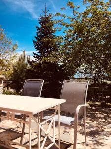 two chairs and a white table and a tree at Ilaeira Mountain Resort in Toriza