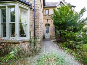 a stone house with a door and a window at The Briary in Sheffield