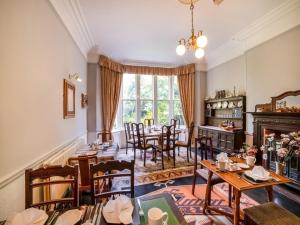 a dining room with tables and chairs and a fireplace at The Briary in Sheffield