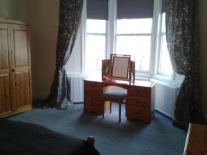 a bedroom with a desk in front of a window at Avenue Road in Gateshead