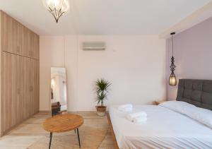 a small bedroom with a bed and a table at Iliovasilema in Platy