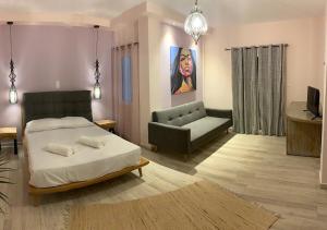 a living room with a bed and a couch at Iliovasilema in Platy