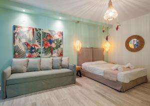 a bedroom with a bed and a couch in it at Iliovasilema in Platy +37 photos