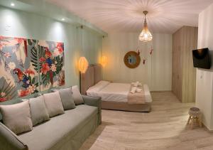 a living room with a couch and a bed at Iliovasilema in Platy