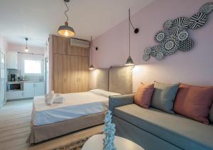 a living room with a bed and a couch at Iliovasilema in Platy