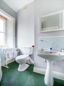 a white bathroom with a toilet and a sink at The Briary in Sheffield +33 photos