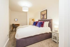 a bedroom with a large bed and a desk at One Moorgate View in York