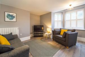 a living room with a couch and a tv at ONE MOORGATE VIEW in York