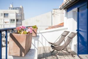 a balcony with two chairs and flowers on a balcony at Le Ryad Boutique Hôtel in Marseille